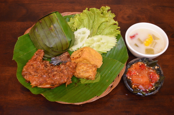 A meal with rice, vegetables and sambal